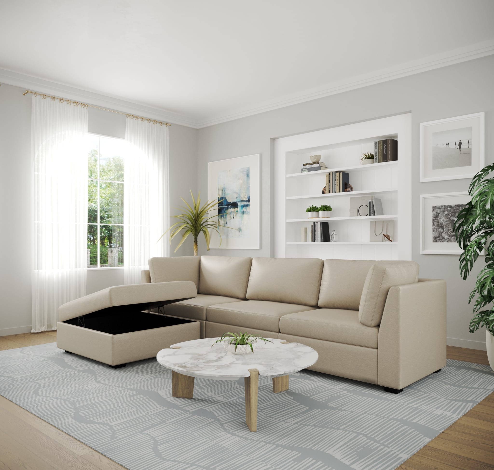 Beige leather modular sectional with the lift-top storage chaise open, in a bright room with white built-in shelving and a round marble coffee table