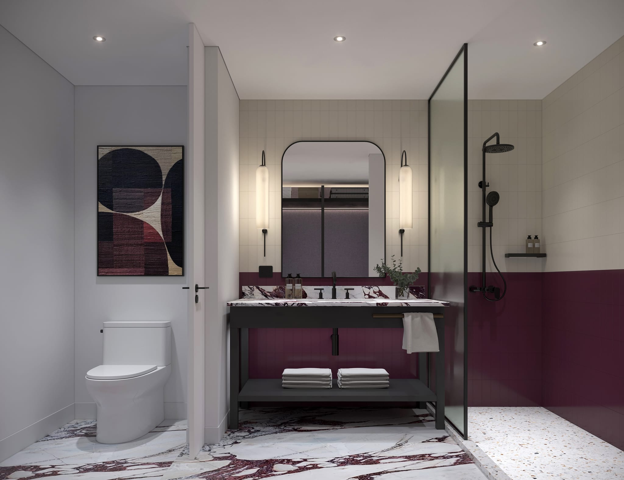 Hotel en-suite bathroom with burgundy marble vanity top on a black steel frame, plum vertical tile, arched mirror between glass sconces and a walk-in shower with terrazzo floor